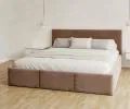Čalúnená posteľ AMBER 180x200 Hnedá Trinity s úložným priestorom a dreveným roštom