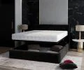 Čalúnená posteľ JUSTIN 140x200 Čierná Trinity s úložným priestorom kovový rošt